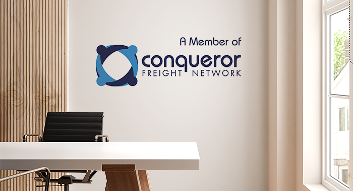 A member of Conqueror Freight Network logo place in an office